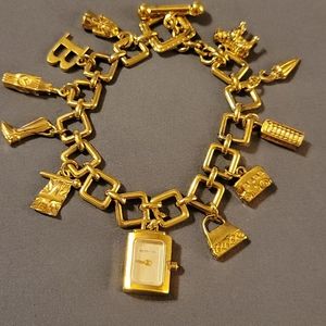 Burberry gold tone charm bracelet